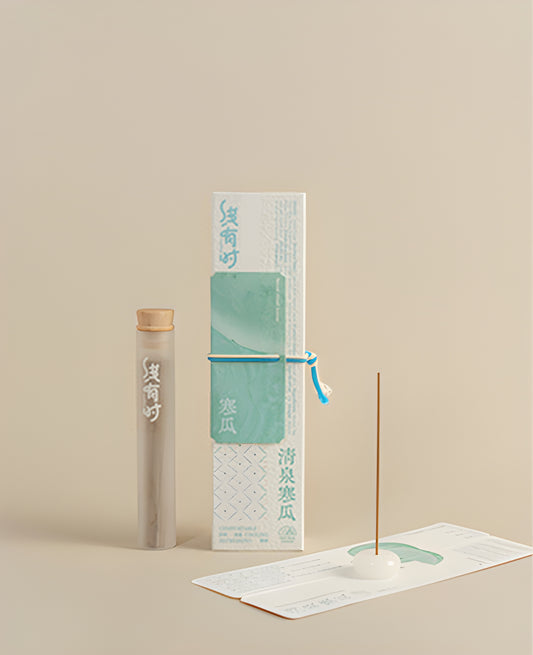 Melon note incense set with a storage tube, pale round holder and white-and-teal presentation box.