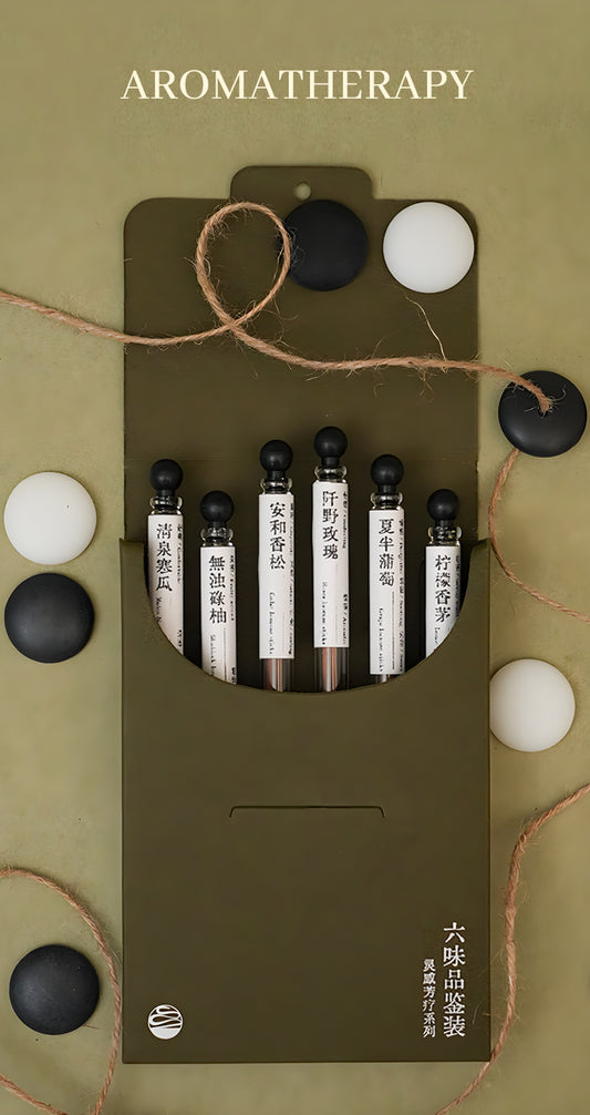 Open six-fragrance incense discovery set with six labeled glass tubes in an olive-green folding box.