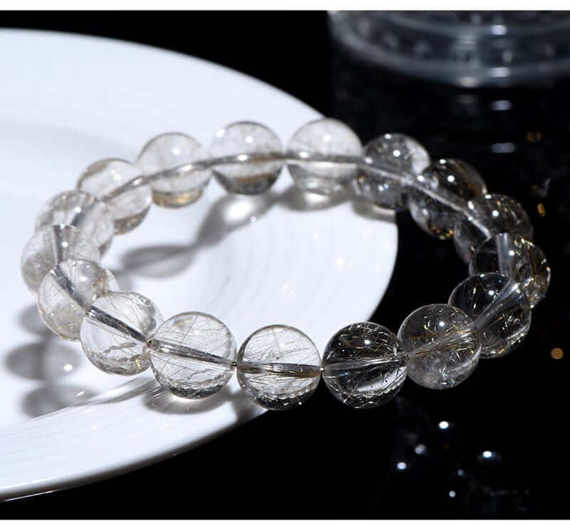 High-grade Silver Rutilated Quartz bracelet with clear polished beads and visible silver rutile inclusions.
