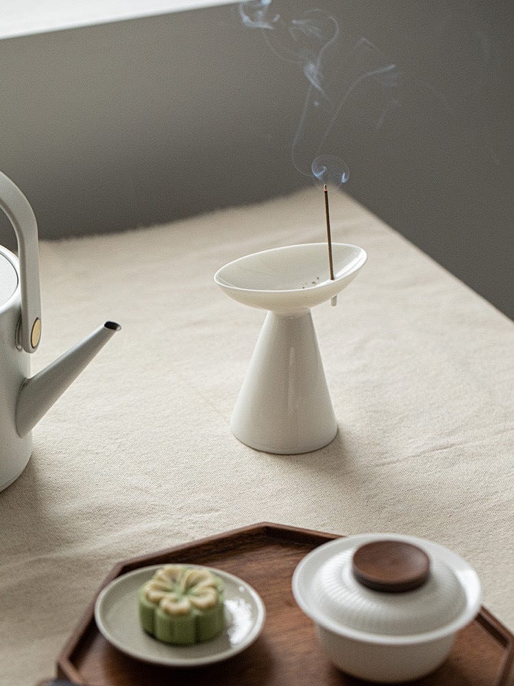 A minimalist celadon incense holder with a jade-like glaze, evoking calmness and clarity in a tranquil Zen-inspired setting.