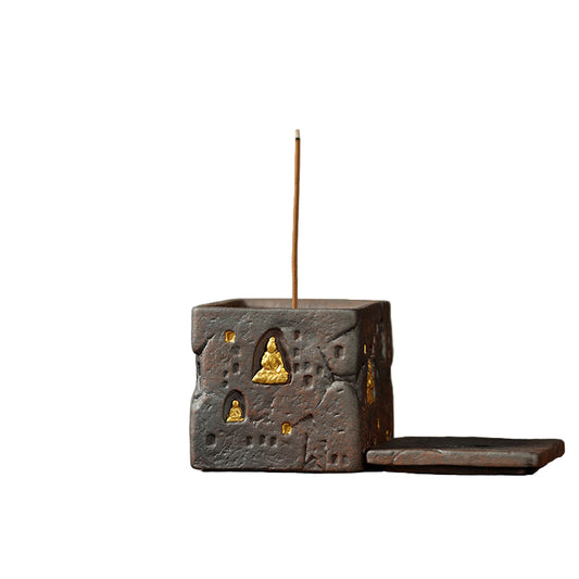 Incense burner with incense stick on a wooden surface, featuring MUYANTEA branding.