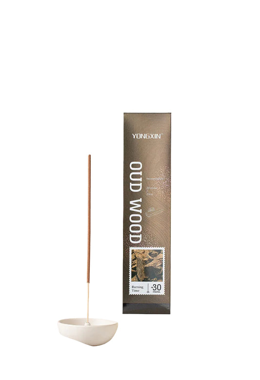 YUNXIN Oud Wood incense stick packaging with incense sticks on a white surface.