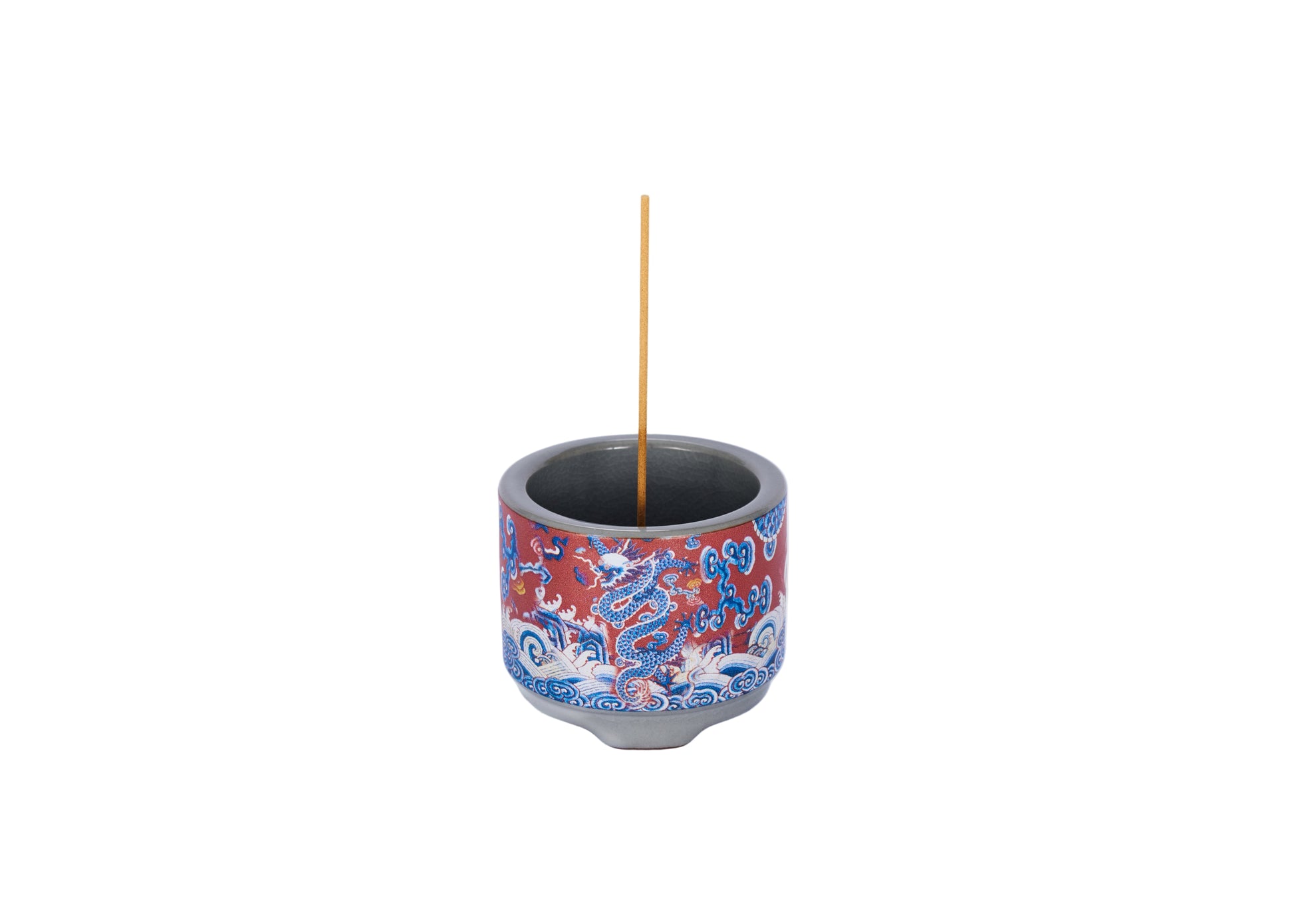 Decorative incense holder with red and blue dragon design on a white background