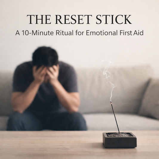 Anxious man sitting on a sofa with lit incense in a square burner, minimalist emotional reset ritual