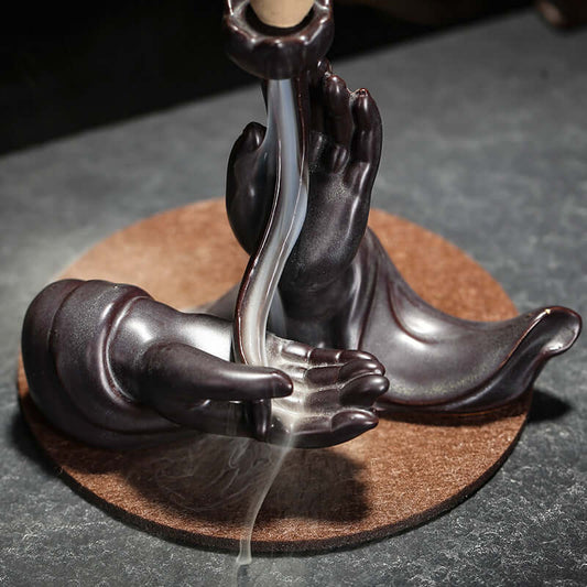 Buddha hand backflow incense burner with cascading smoke — a symbolic expression of stillness and mindful flow in Monian’s Zen rituals.