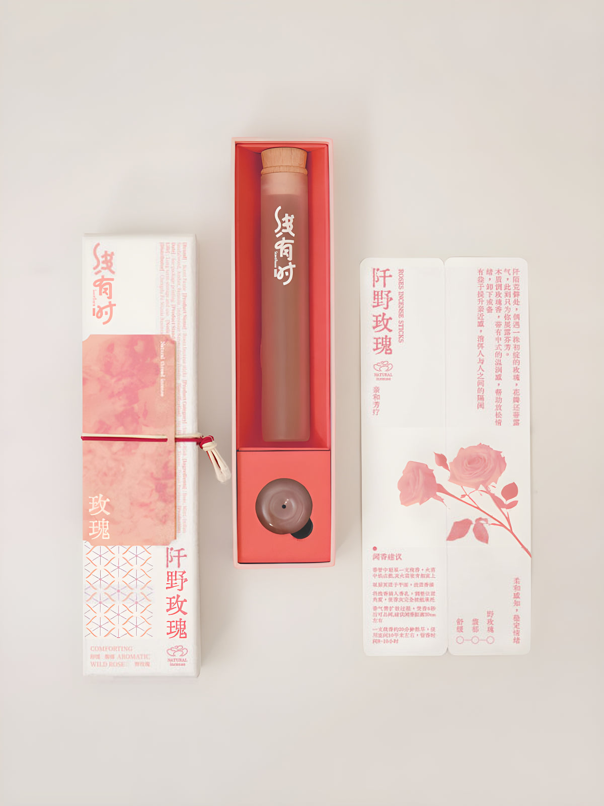 Open rose incense box displaying a slim storage tube, round holder and rose-illustrated insert.
