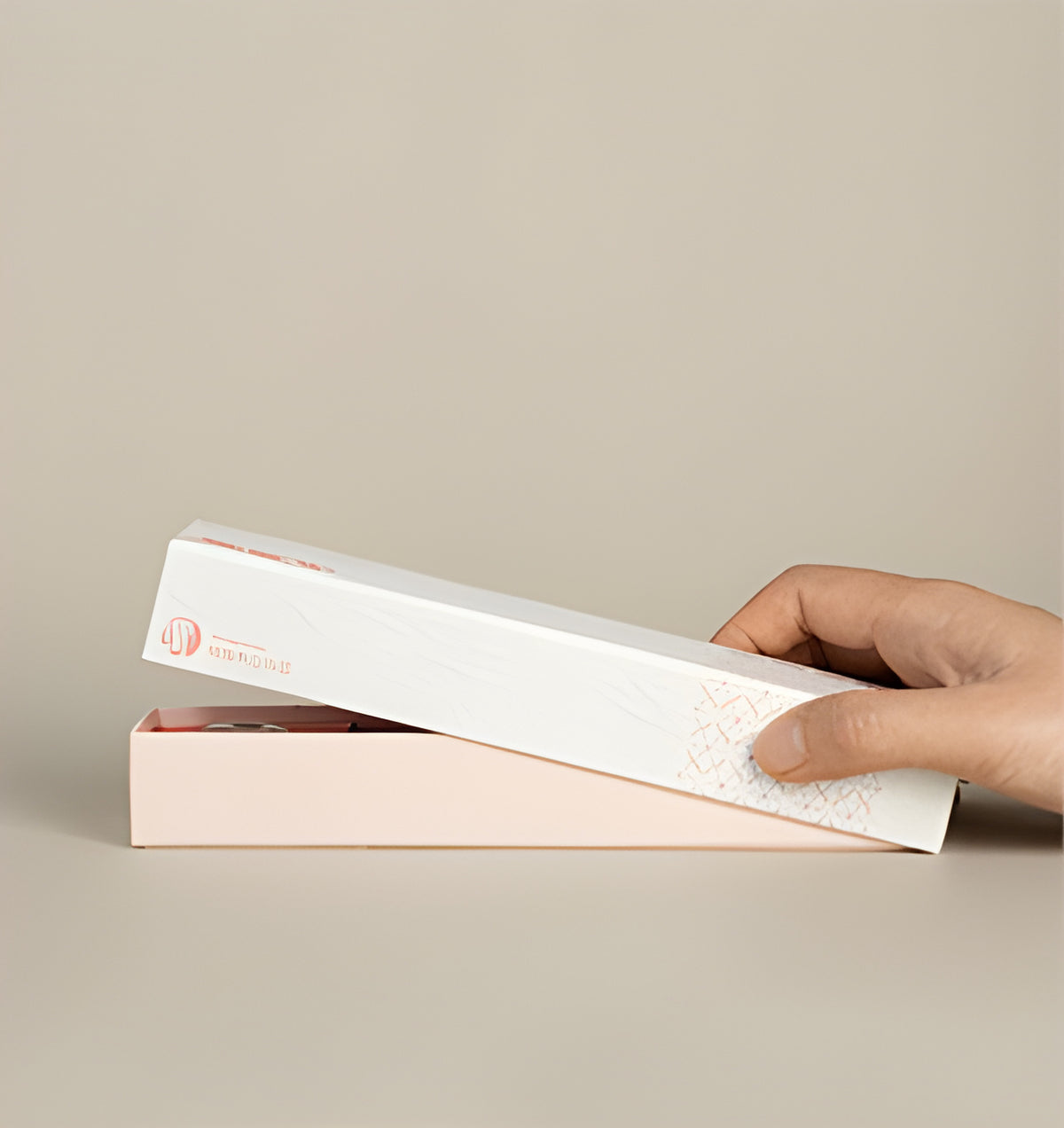 Hand lifting the cream sleeve from the pink rose incense presentation box.