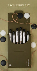 Open six-scent discovery set with six individually labeled incense tubes in an olive-green folding box.