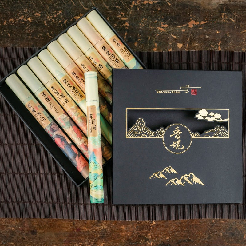 Set of traditional Chinese painting brushes in a decorative box on a wooden surface