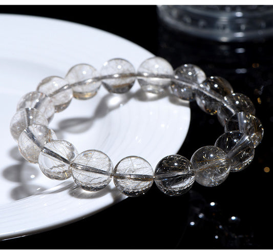 High-grade Silver Rutilated Quartz bracelet with clear polished beads and visible silver rutile inclusions.