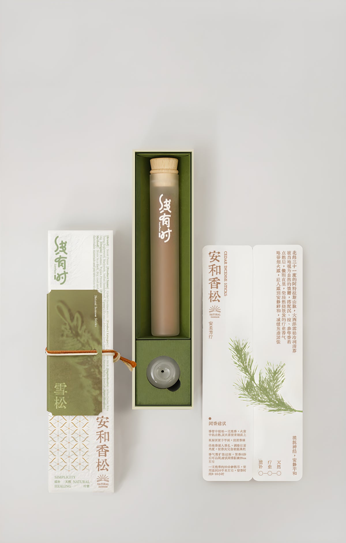 Cedar incense gift box with its olive-green tray, storage tube, round holder and botanical insert.