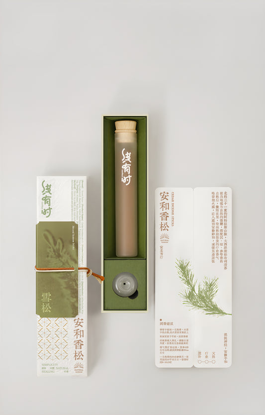 Cedar incense gift box with its olive-green tray, storage tube, round holder and botanical insert.