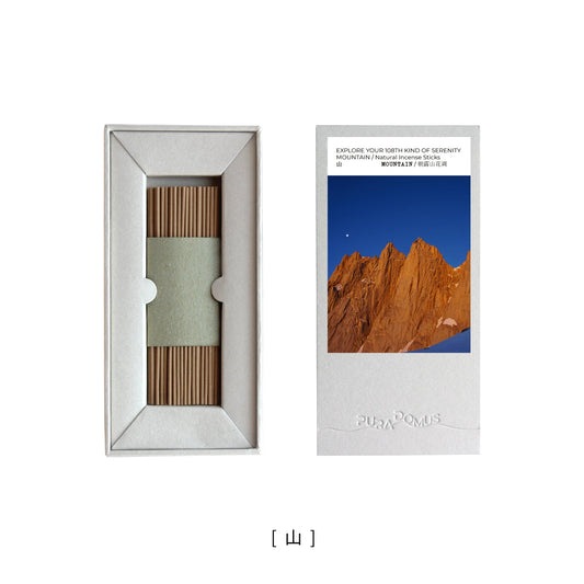 A minimalist incense stick burning atop a reflective mountain-shaped ceramic holder, surrounded by natural elements—evoking dawn mist, alpine qi, and the grounded presence of Earth.