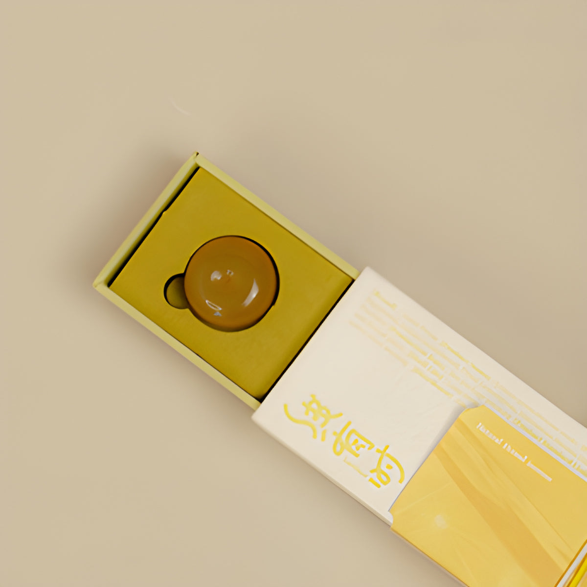 Yellow incense holder nested inside the lemongrass incense presentation box.