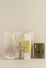 Incense Beginner Set with a yellow lemongrass incense box, six-scent sampler, burner and cream gift bag.