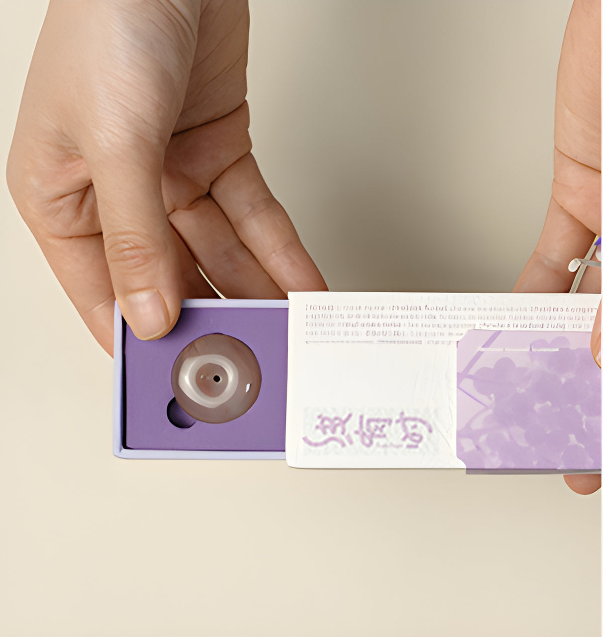 Hands sliding open the grape incense box to reveal the purple tray and round holder.