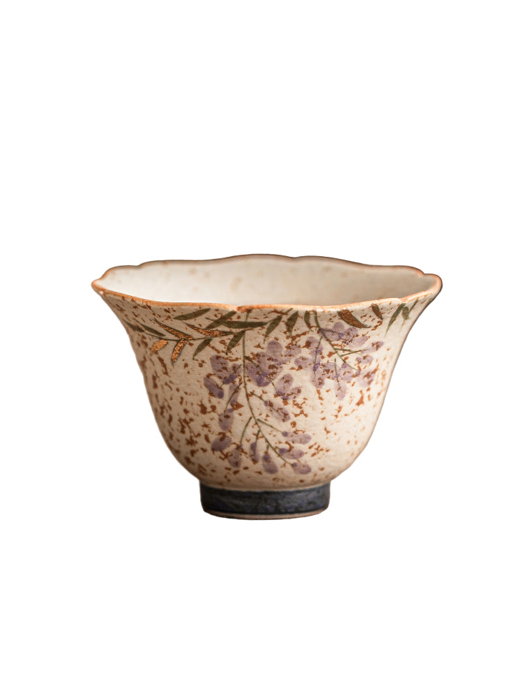 Ceramic cup with floral design on a textured surface