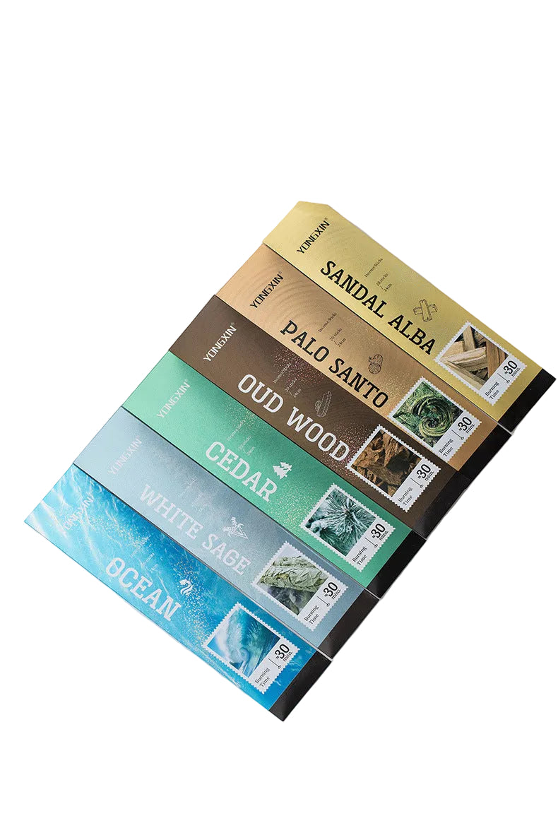 Stack of books with different scents on a white surface