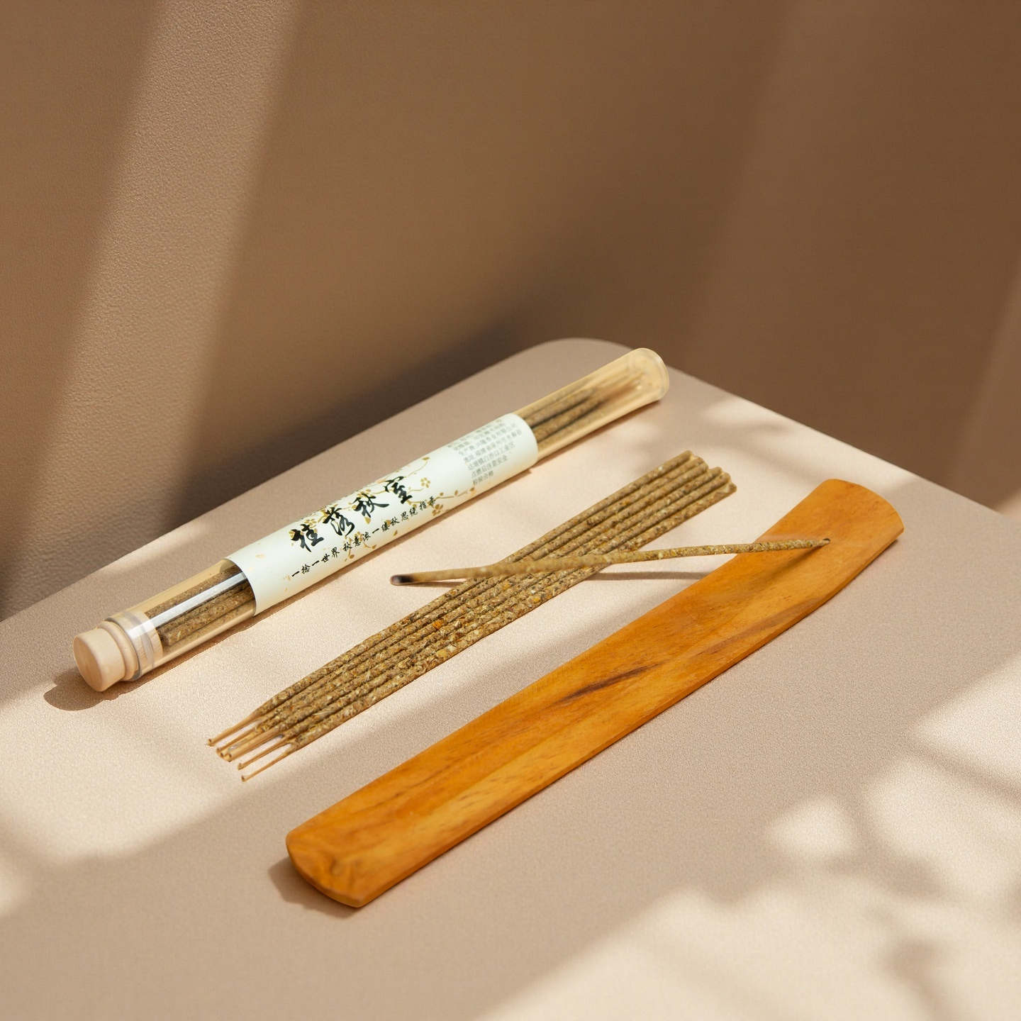 Bamboo incense stick holder with incense sticks on a beige surface
