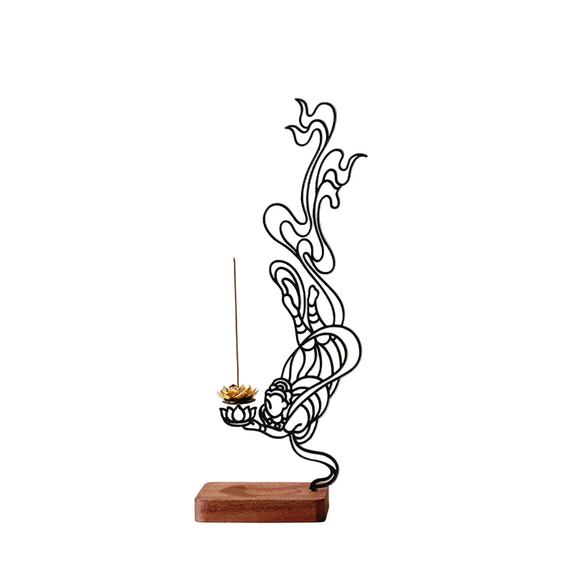 Decorative metal sculpture of a figure holding a lotus flower with incense on a beige background