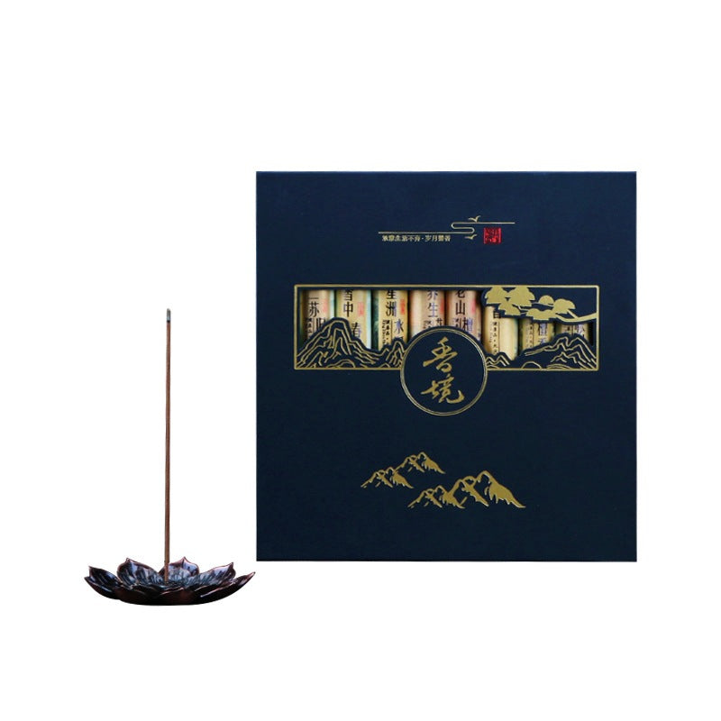 Incense stick with a decorative box featuring mountain designs on a white background