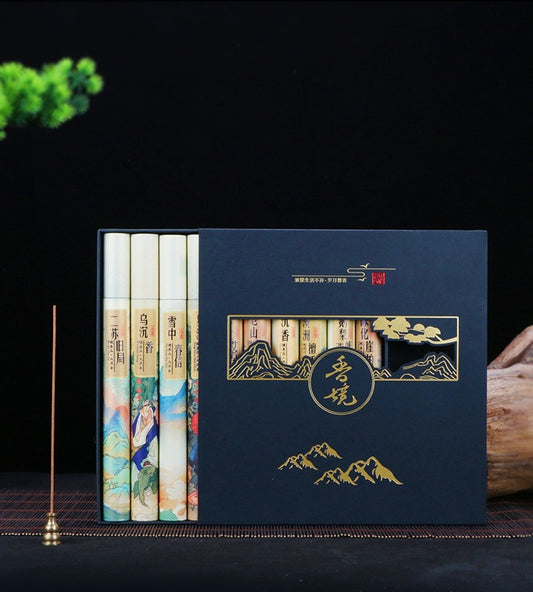 Set of books with decorative cover featuring mountain and cloud design on a dark background