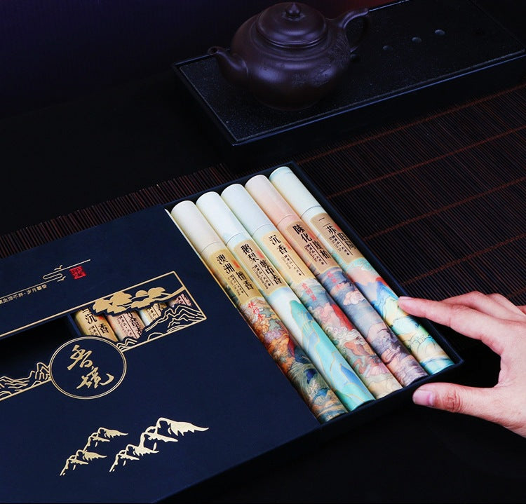 Set of colorful inkstones with a decorative box on a dark surface