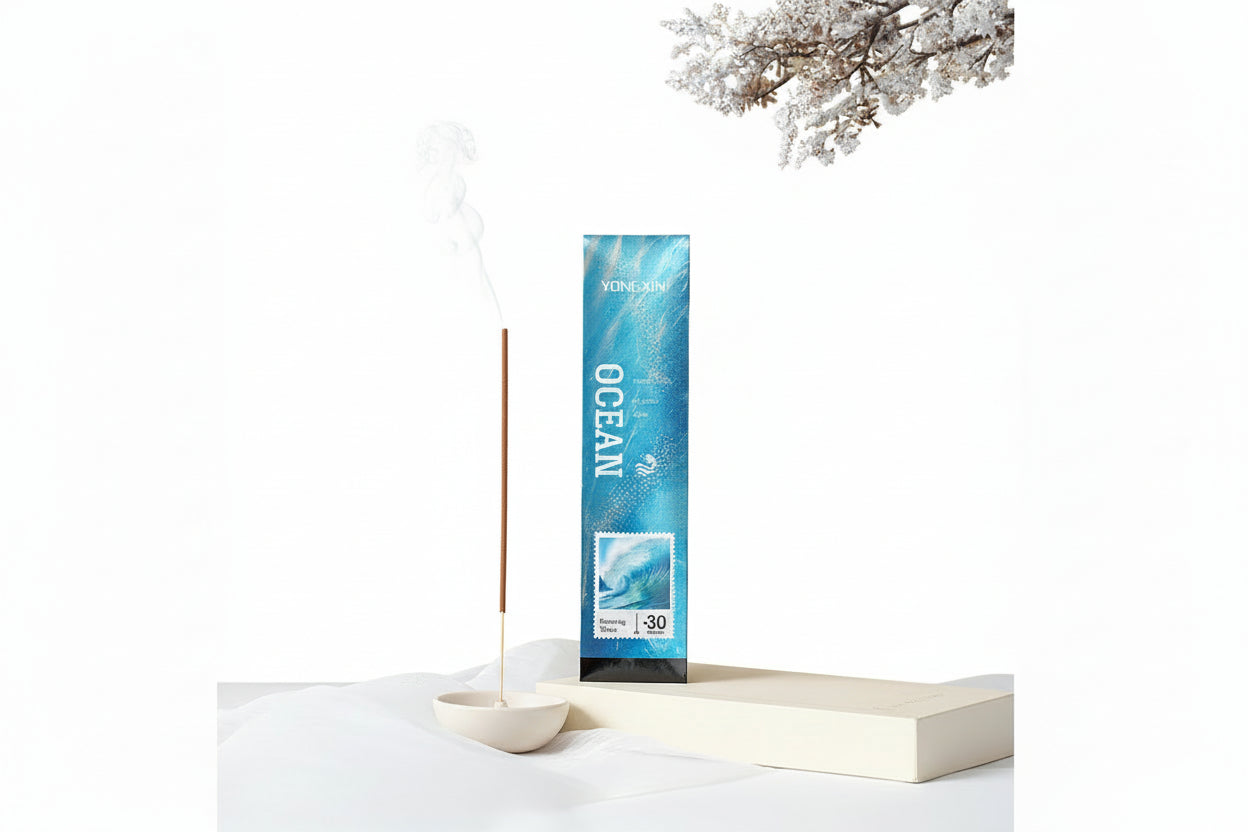 Incense stick with packaging labeled 'Ocean' on a white surface with a minimal background