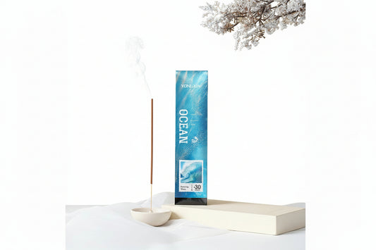 Incense stick with packaging labeled 'Ocean' on a white surface with a minimal background