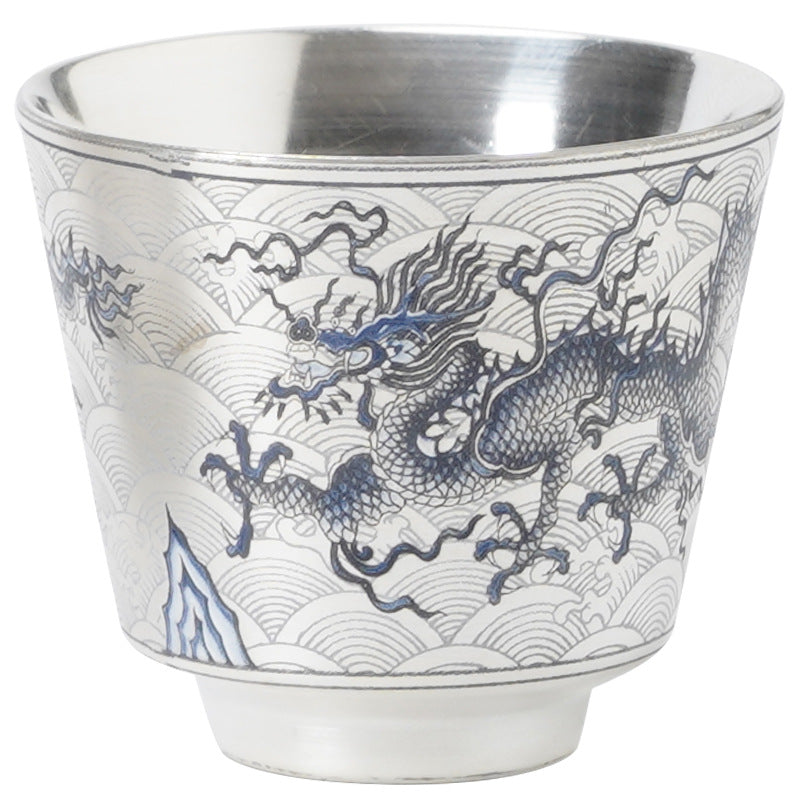 Ceramic cup with blue dragon design on a white background
