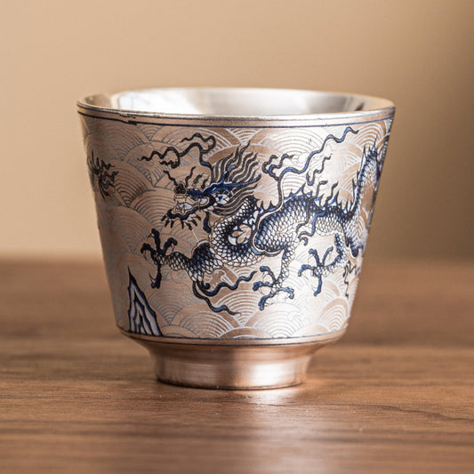 Ceramic cup with dragon design on a wooden surface