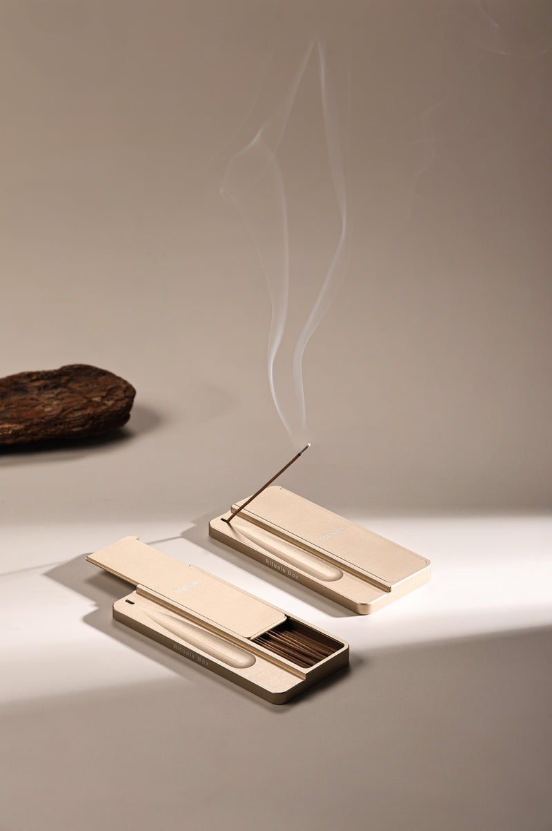 Monian Rituals Box champagne gold aluminum incense holder with smoke rising — portable meditation tool